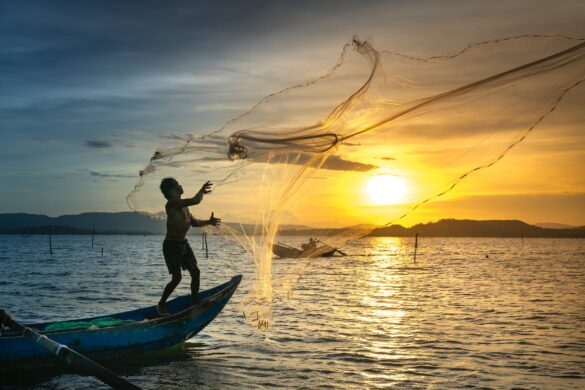 Fisherman throwing Fish Net on Lake Fisherman throwing Fish Net on Lake