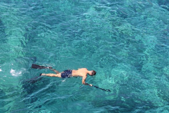 Man Snorkeling in Blue Ocean Water Man Snorkeling in Blue Ocean Water