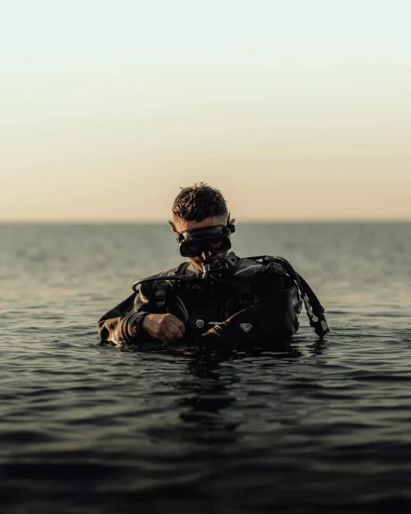 Scuba Diver Standing Waist Deep in the Water Scuba Diver Standing Waist Deep in the Water