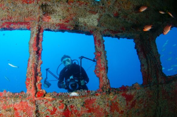 Underwater Photograph of a Diver with Red Wreck Underwater Photograph of a Diver with Red Wreck