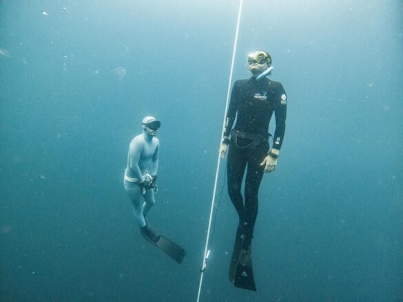 Breath-holding Diver Emerging Under the Supervision of Another Freediver Breath-holding Diver Emerging Under the Supervision of Another Freediver
